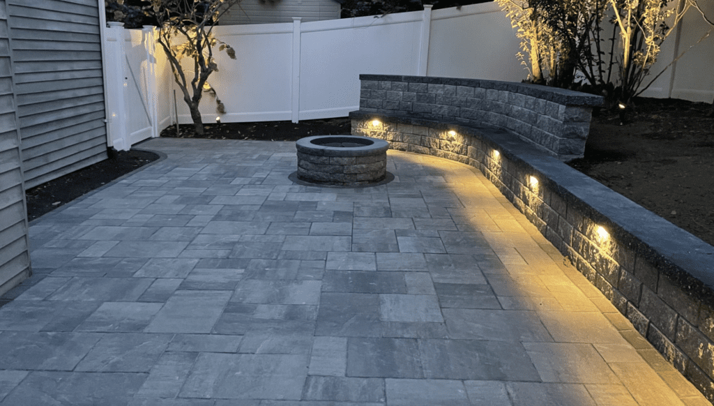 outdoor fire pit with landscape lighting by Leahy Landscaping
