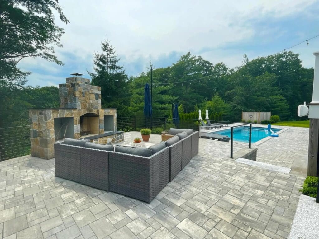 Pool landscaping and masonry with outdoor fire pit and outdoor fireplace in Massachusetts