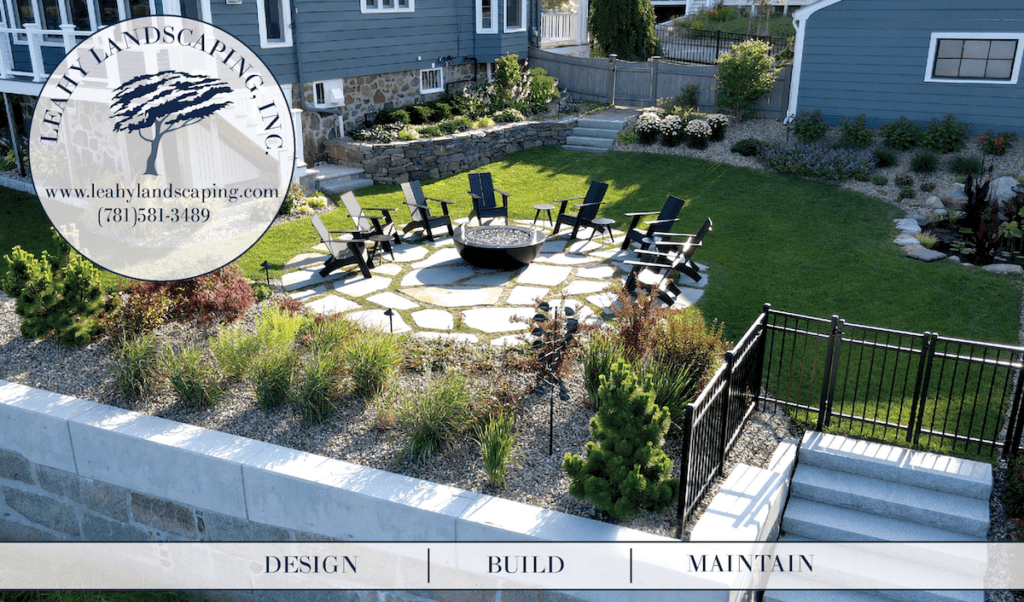 Stone patio and outdoor fire pit with chairs. Marblehead, MA luxury landscaping services.